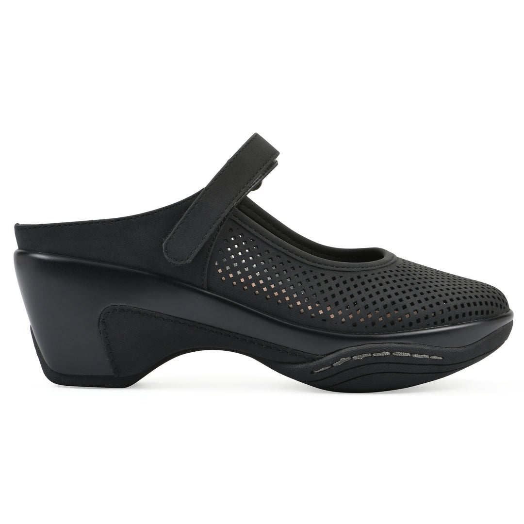 Side view of a black colored clog with a closed toe and adjustable strap, featuring a perforated diamond design and a low heel.