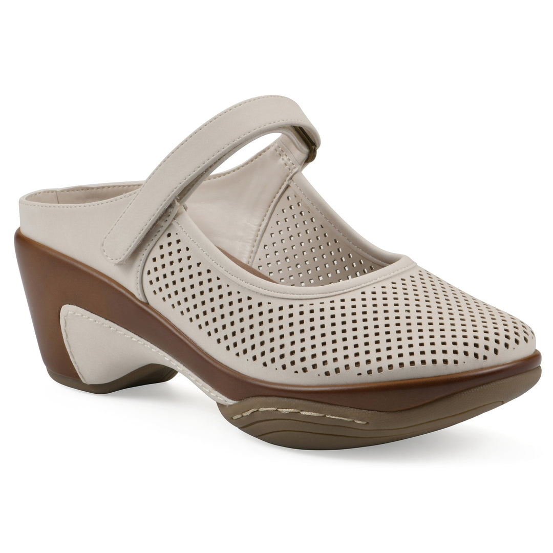 Angel view of a egg shell colored clog with a closed toe and adjustable strap, featuring a perforated diamond design and a low heel.