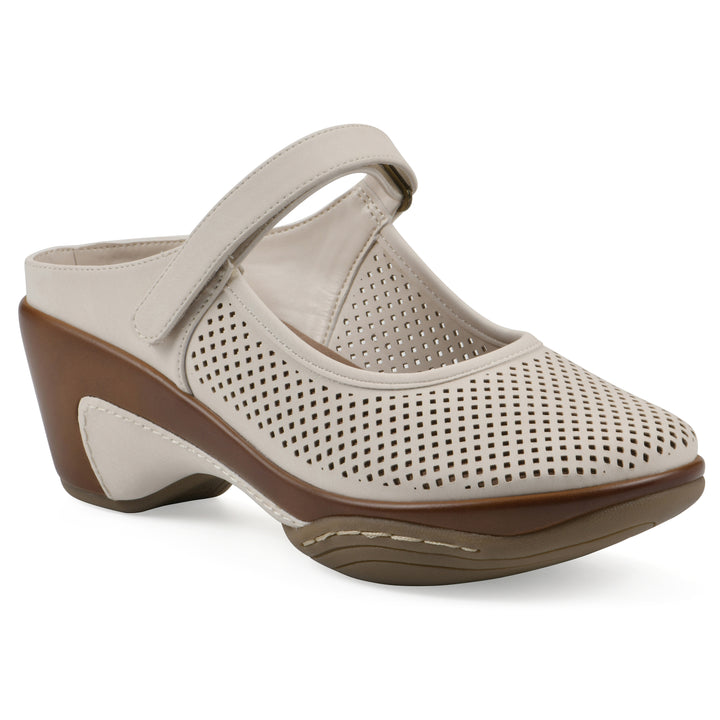 Angel view of a egg shell colored clog with a closed toe and adjustable strap, featuring a perforated diamond design and a low heel.