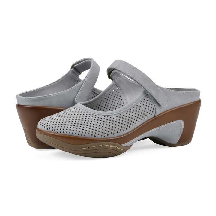 Angel view of a pair of pastel blue colored clog with a closed toe and adjustable strap, featuring a perforated diamond design and a low heel.