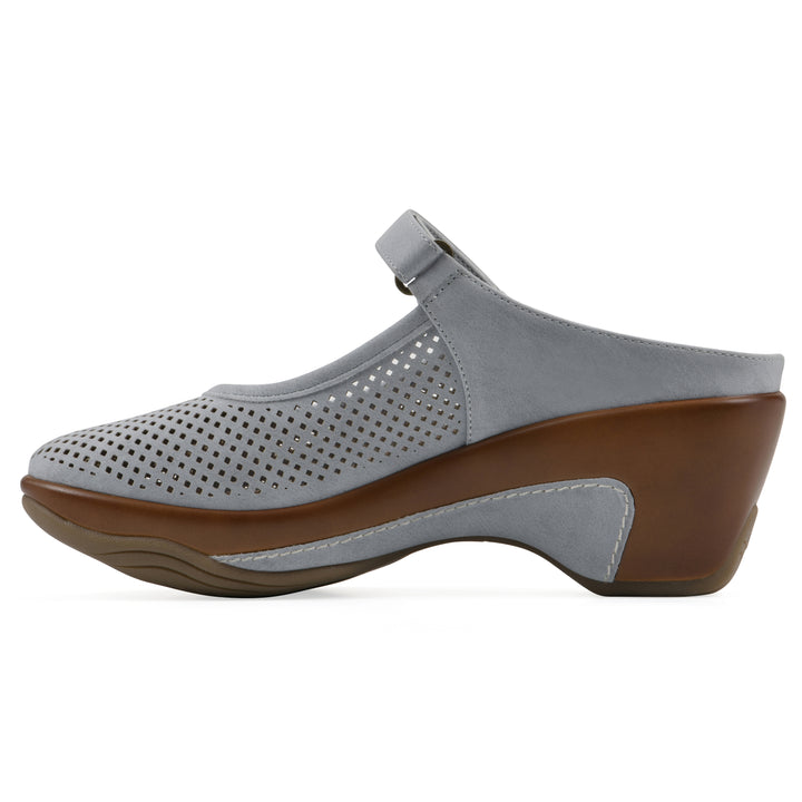 Side view of a pastel blue colored clog with a closed toe and adjustable strap, featuring a perforated diamond design and a low heel.