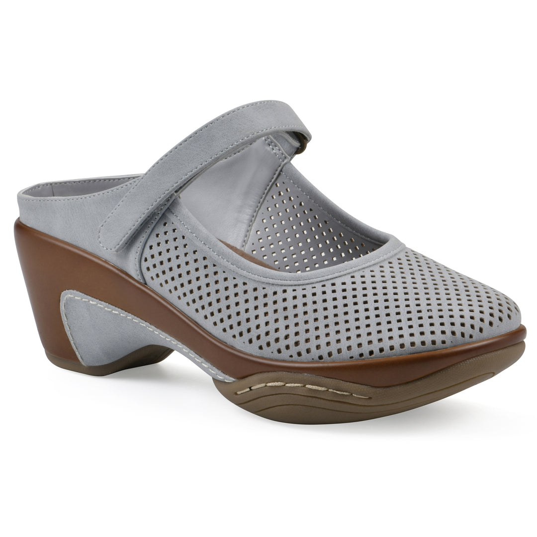 Angel view of a pastel blue colored clog with a closed toe and adjustable strap, featuring a perforated diamond design and a low heel.