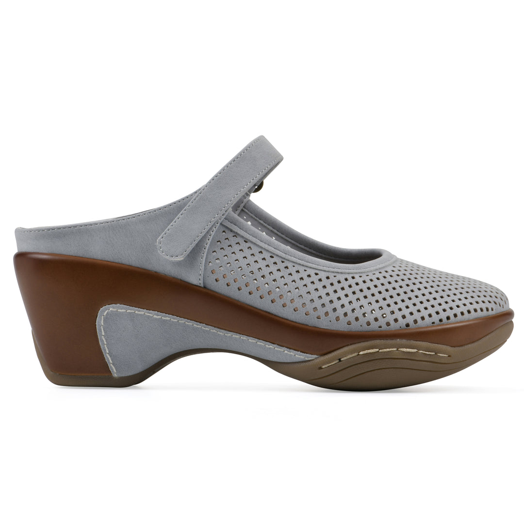 Side view of a pastel blue colored clog with a closed toe and adjustable strap, featuring a perforated diamond design and a low heel.