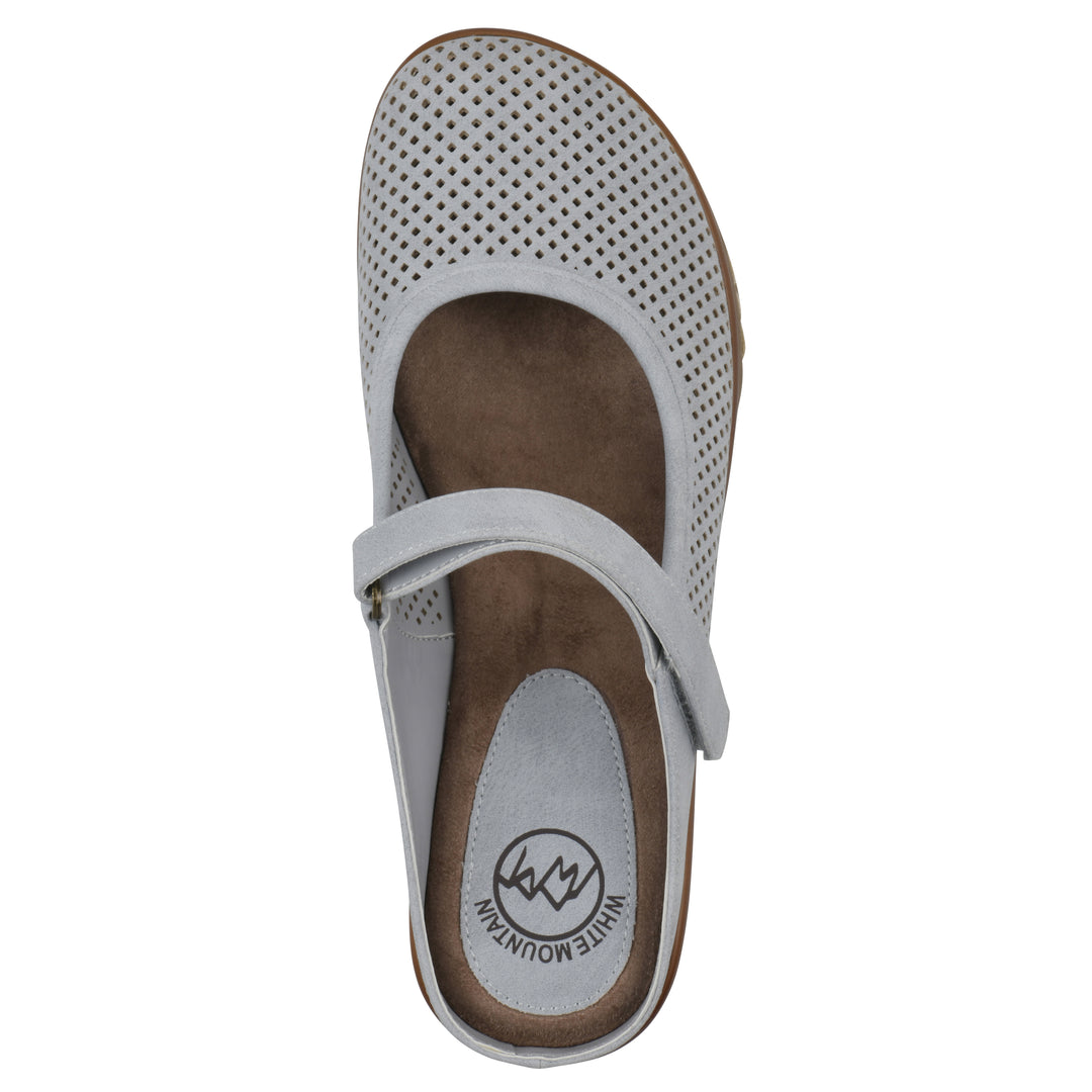 Top view of a pastel blue colored clog with a closed toe and adjustable strap, featuring a perforated diamond design and a low heel.