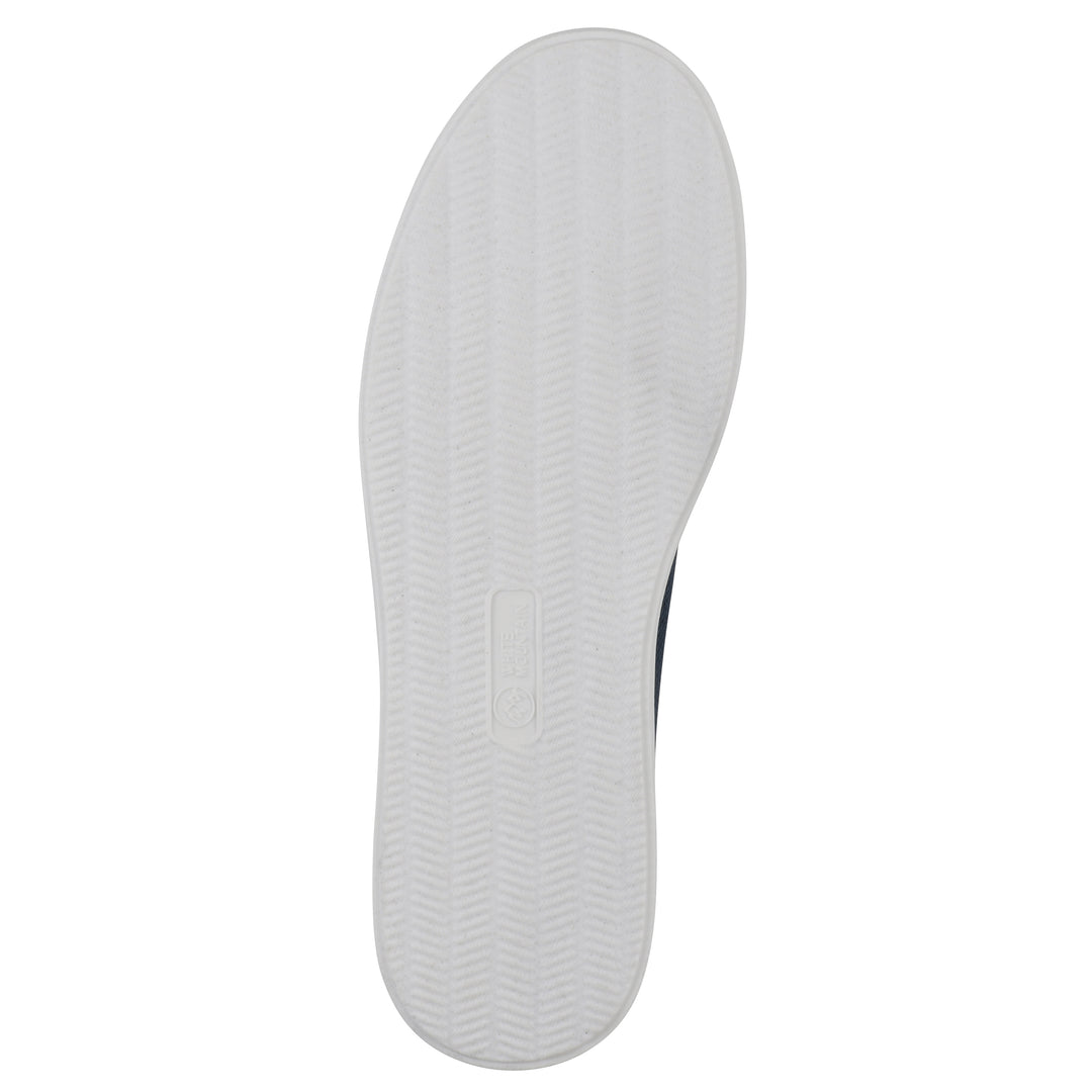 Sole view of a navy slip-on sneaker with white sole, and perforated mesh fabric