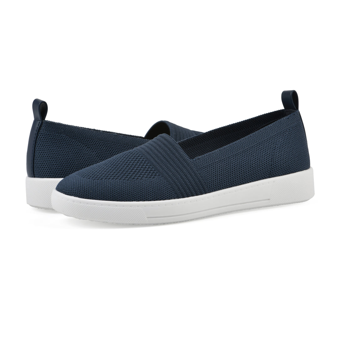 Angle view of a pair of navy slip-on sneaker with white sole, and perforated mesh fabric