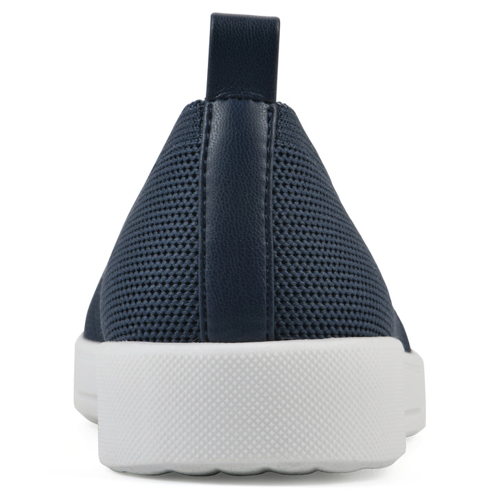 Heel view of a navy slip-on sneaker with white sole, and perforated mesh fabric