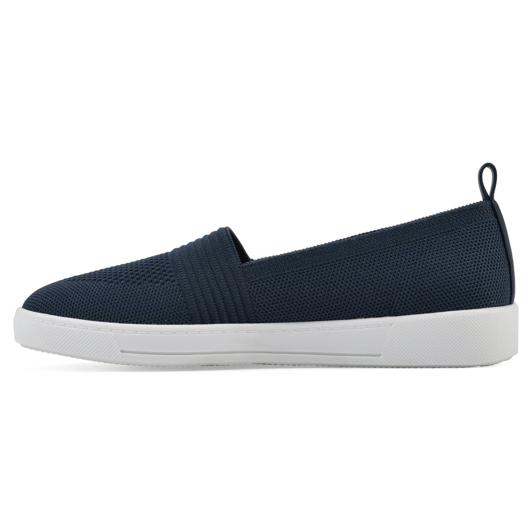 Side view of a navy slip-on sneaker with white sole, and perforated mesh fabric