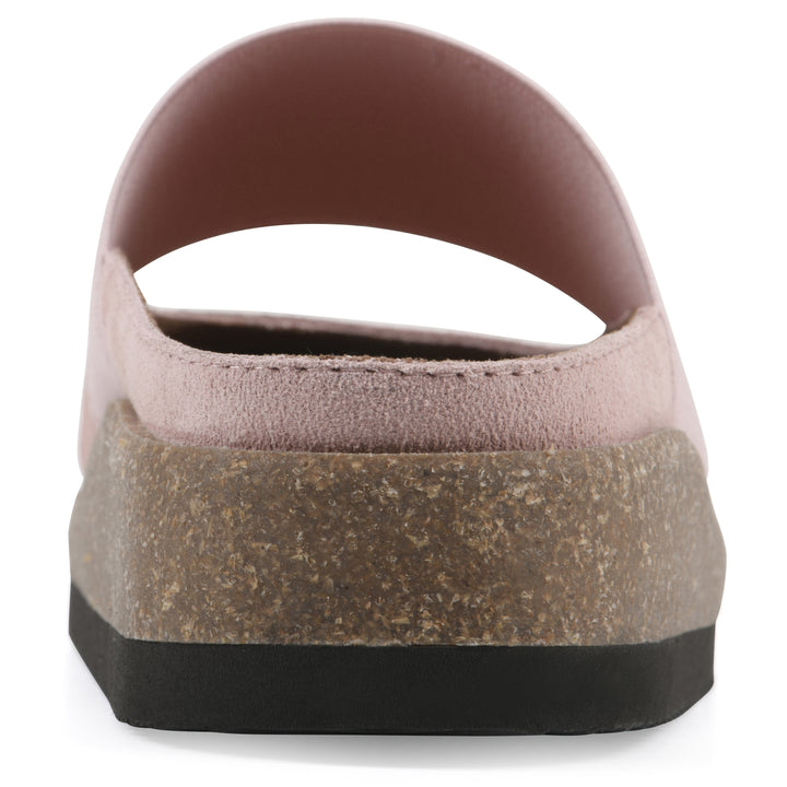 Rear view of a light pink suede backless clog with Mary Jane style center strap and a brown sole with black bottom