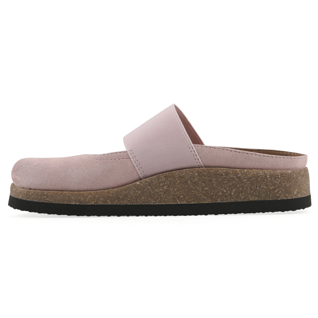 Side view of a light pink suede backless clog with Mary Jane style center strap and a brown sole with black bottom