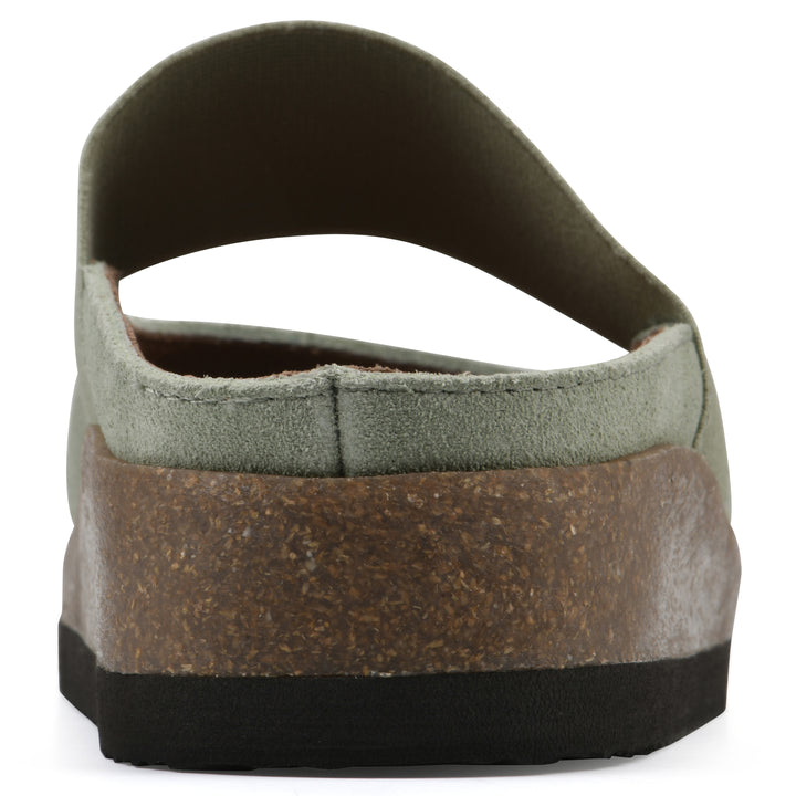 Rear view of a sage suede backless clog with Mary Jane style center strap and a brown sole with black bottom