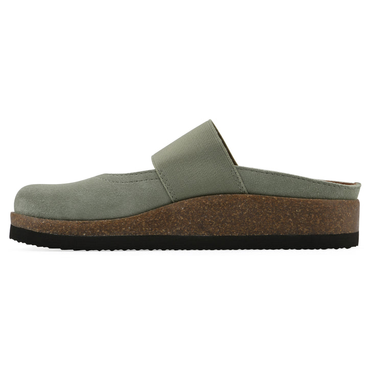 Side view of a sage suede backless clog with Mary Jane style center strap and a brown sole with black bottom