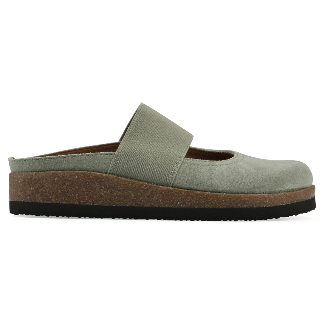 Side view of a sage suede backless clog with Mary Jane style center strap and a brown sole with black bottom