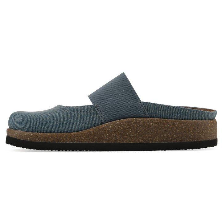 Side view of a denim backless clog with Mary Jane style center strap and a brown sole with black bottom