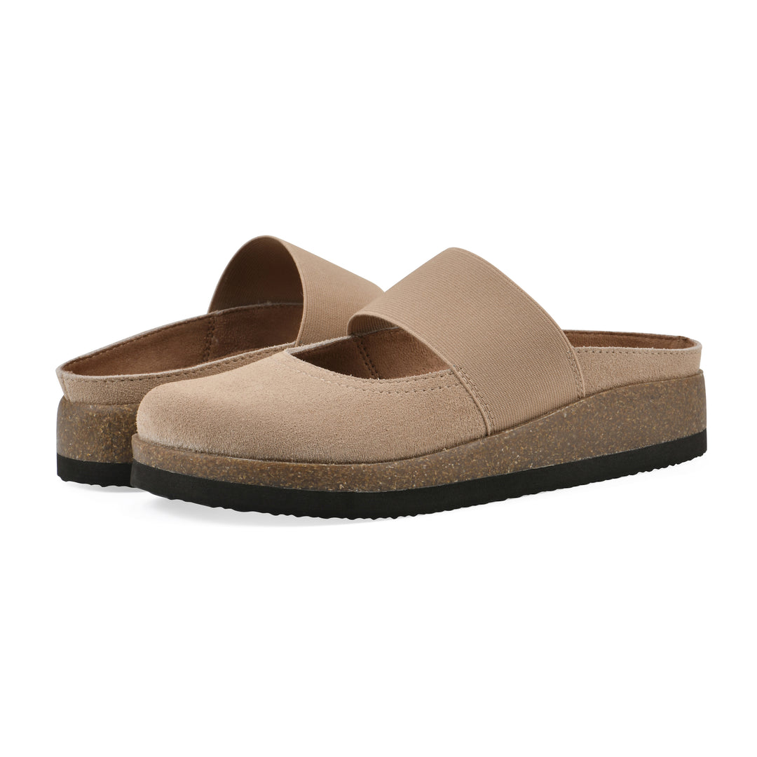 Angle view of a pair of beach wood suede backless clogs with Mary Jane style center strap and a brown sole with black bottom