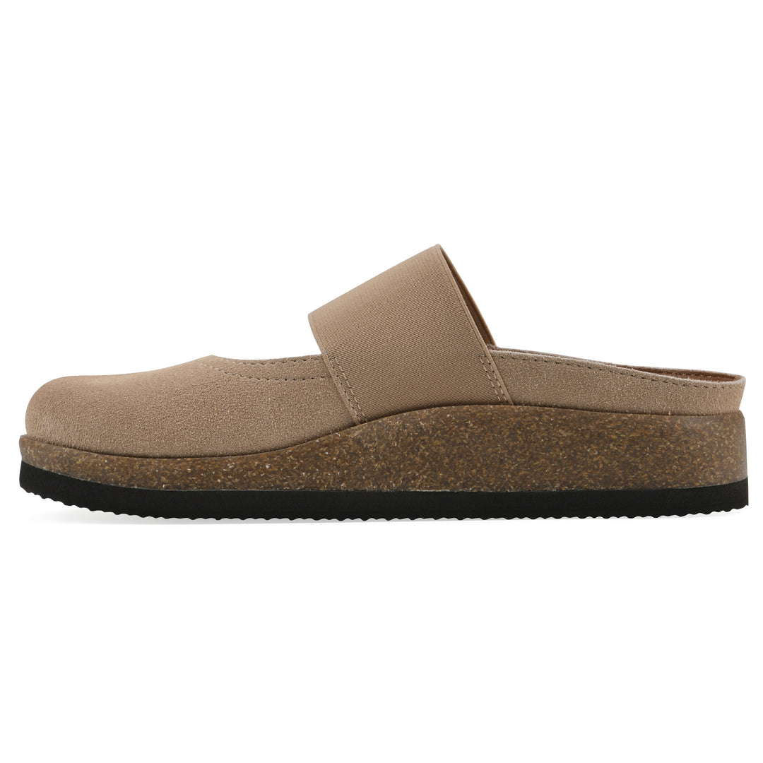 Side view of a beach wood suede backless clog with Mary Jane style center strap and a brown sole with black bottom