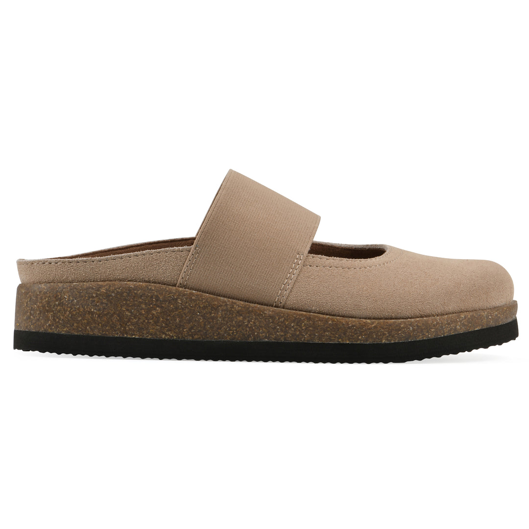 Side view of a beach wood suede backless clog with Mary Jane style center strap and a brown sole with black bottom