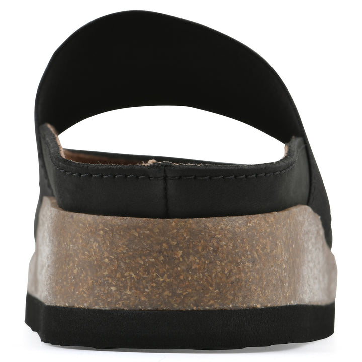 Rear view of a black leather backless clog with Mary Jane style center strap and a brown sole with black bottom