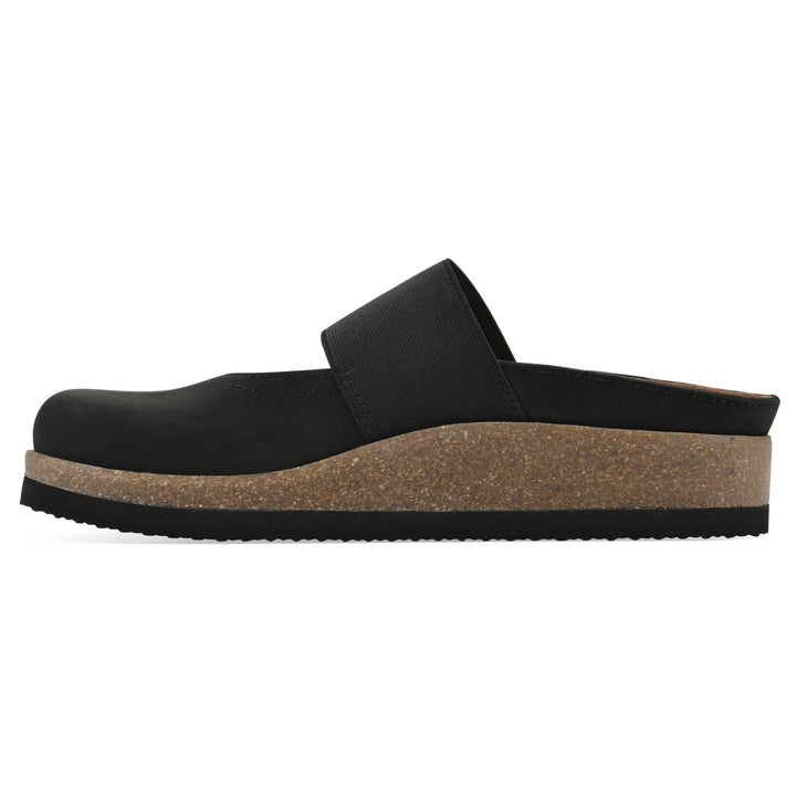 Side view of a black leather backless clog with Mary Jane style center strap and a brown sole with black bottom