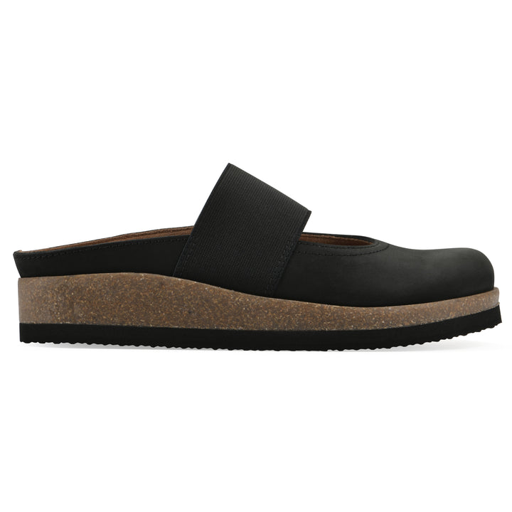 Side view of a black leather backless clog with Mary Jane style center strap and a brown sole with black bottom