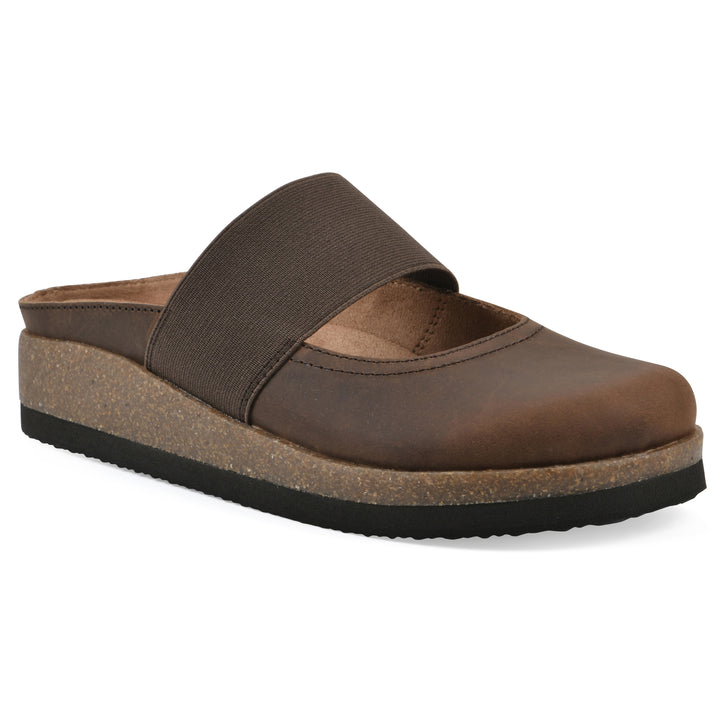 Angle view of a brown leather backless clog with Mary Jane style center strap and a brown sole with black bottom
