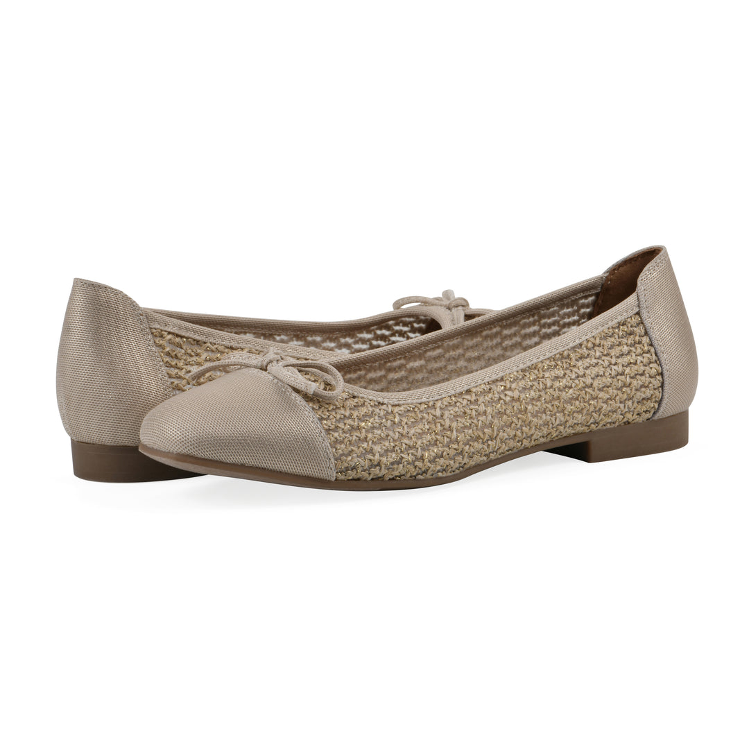 Angle view of a pair of natural metallic raffia flats with small, centered bow and a brown sole