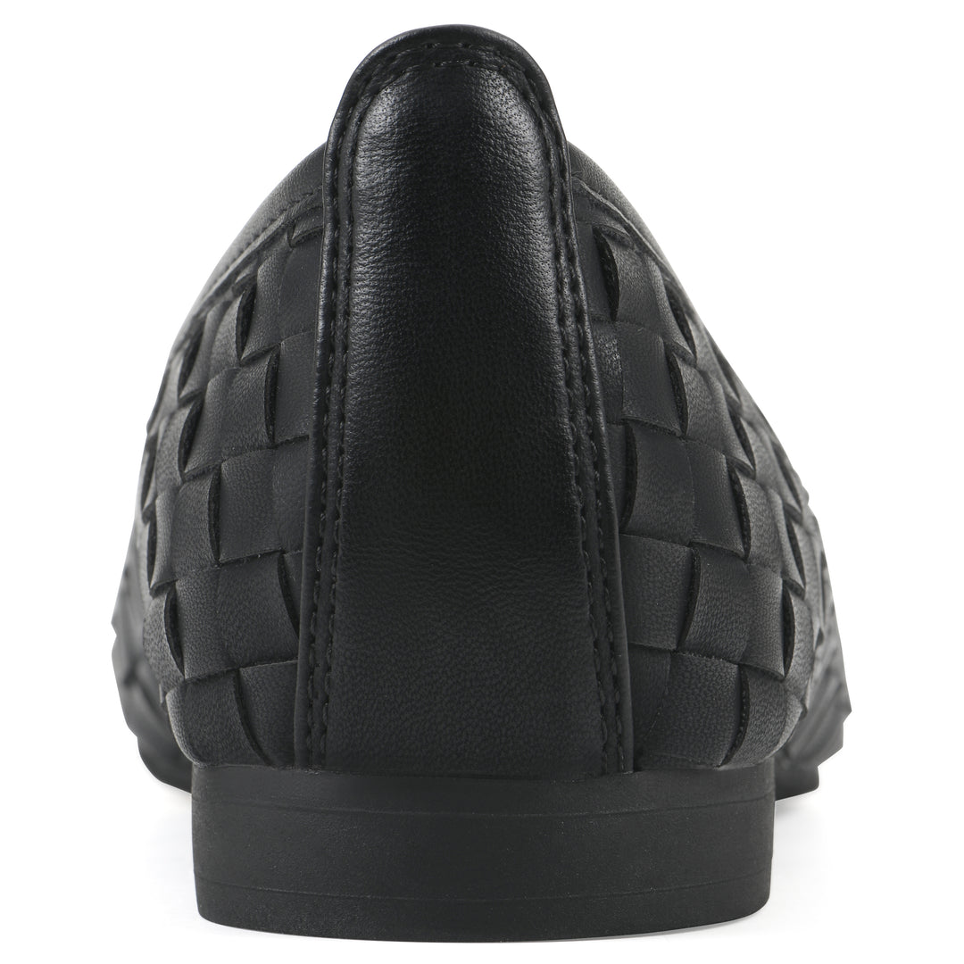 Rear view of a quilted style black flat with low brown sole