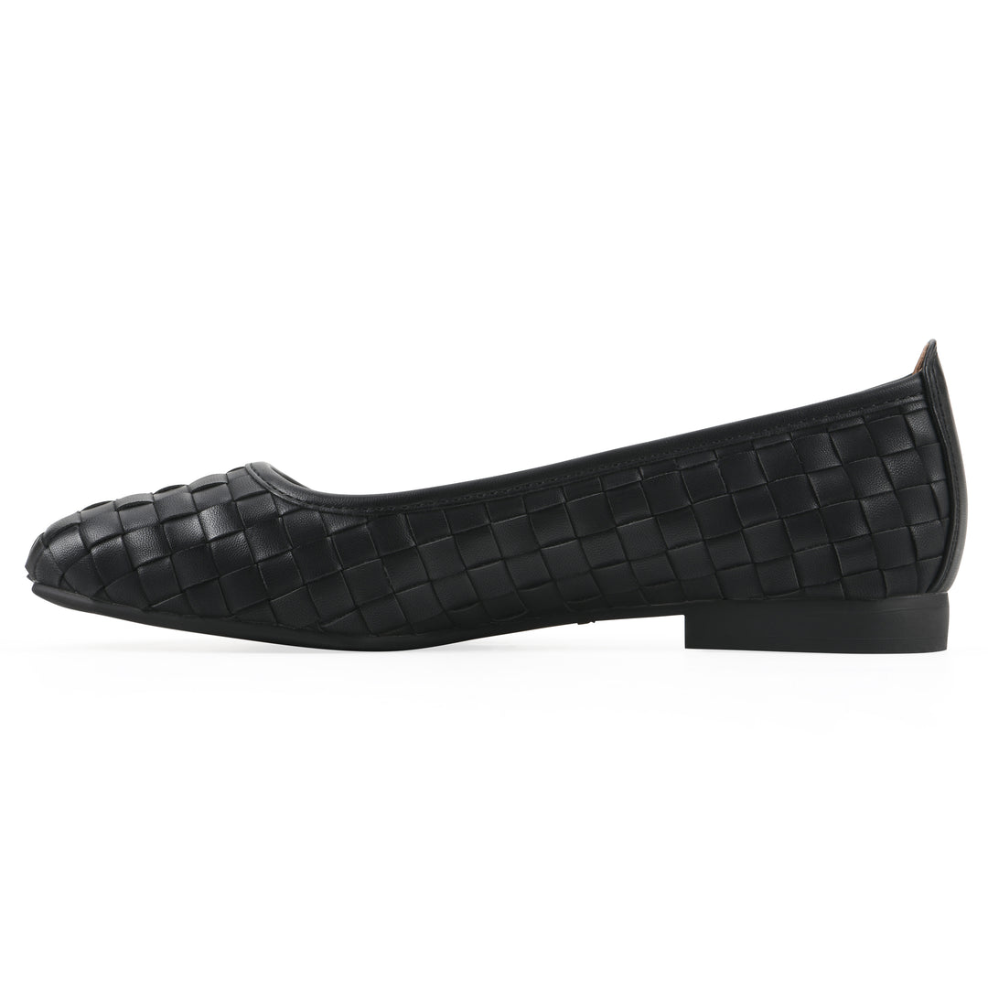 Side view of a quilted style black flat with low brown sole