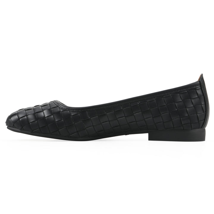 Side view of a quilted style black flat with low brown sole