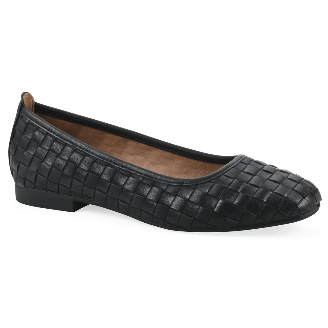 Angle view of a quilted style black flat with low brown sole