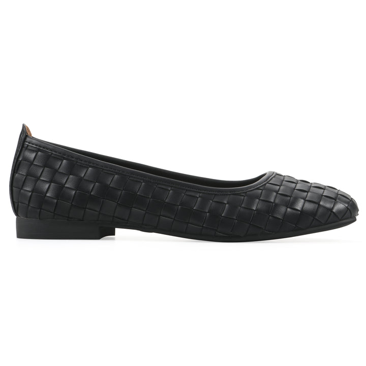 Side view of a quilted style black flat with low brown sole