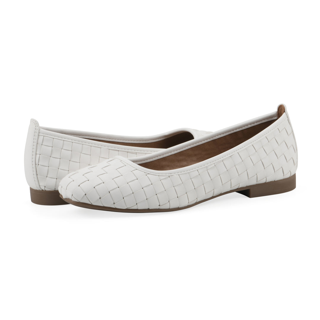 Angle view of a pair of quilted style white flats with low brown sole