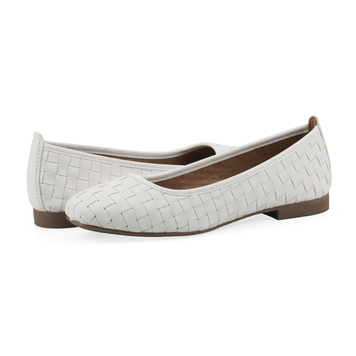 Angle view of a pair of quilted style white flats with low brown sole