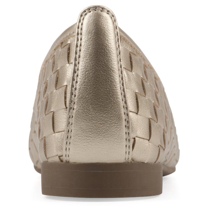 Rear view of a quilted style light gold flat with low brown sole