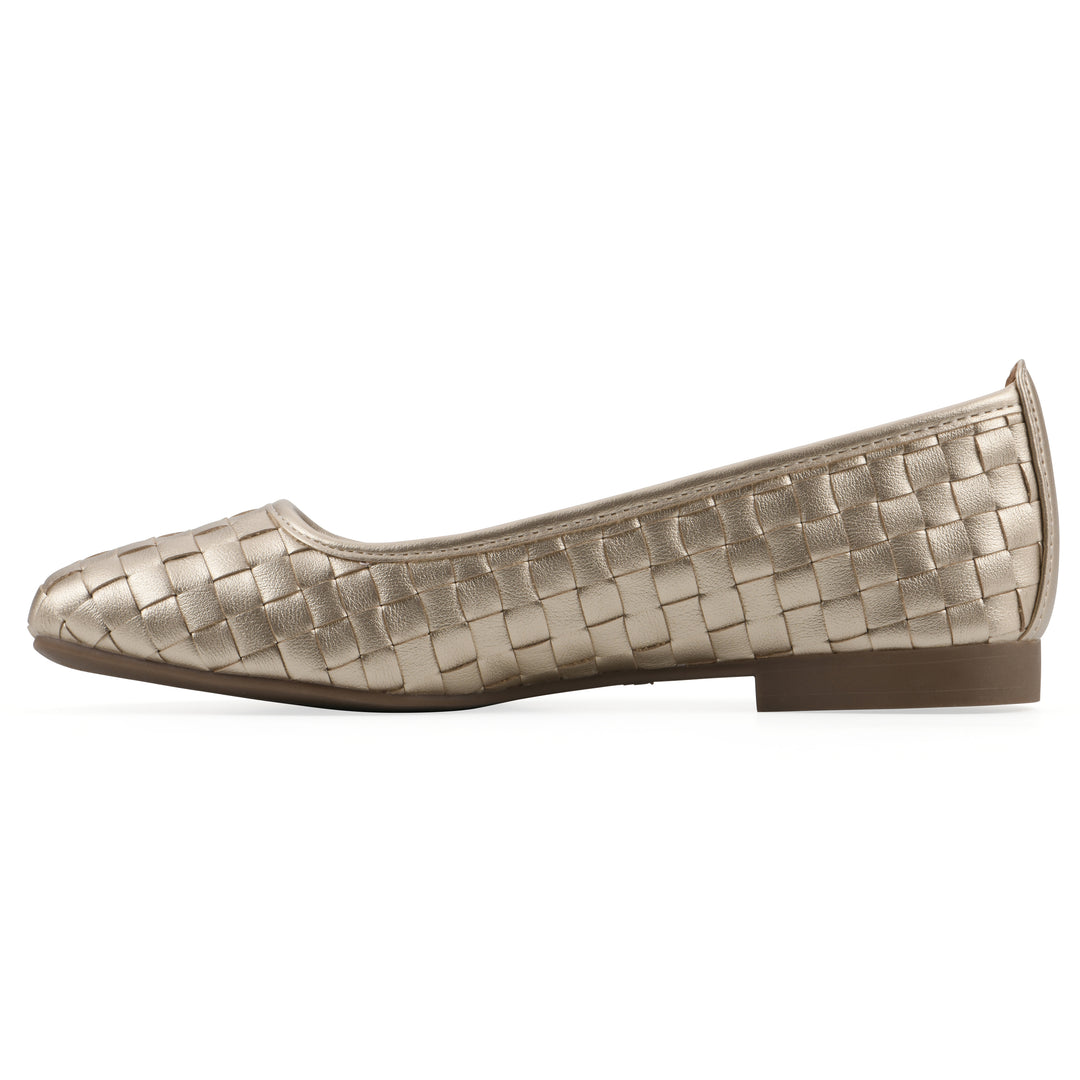 Side view of a quilted style light gold flat with low brown sole
