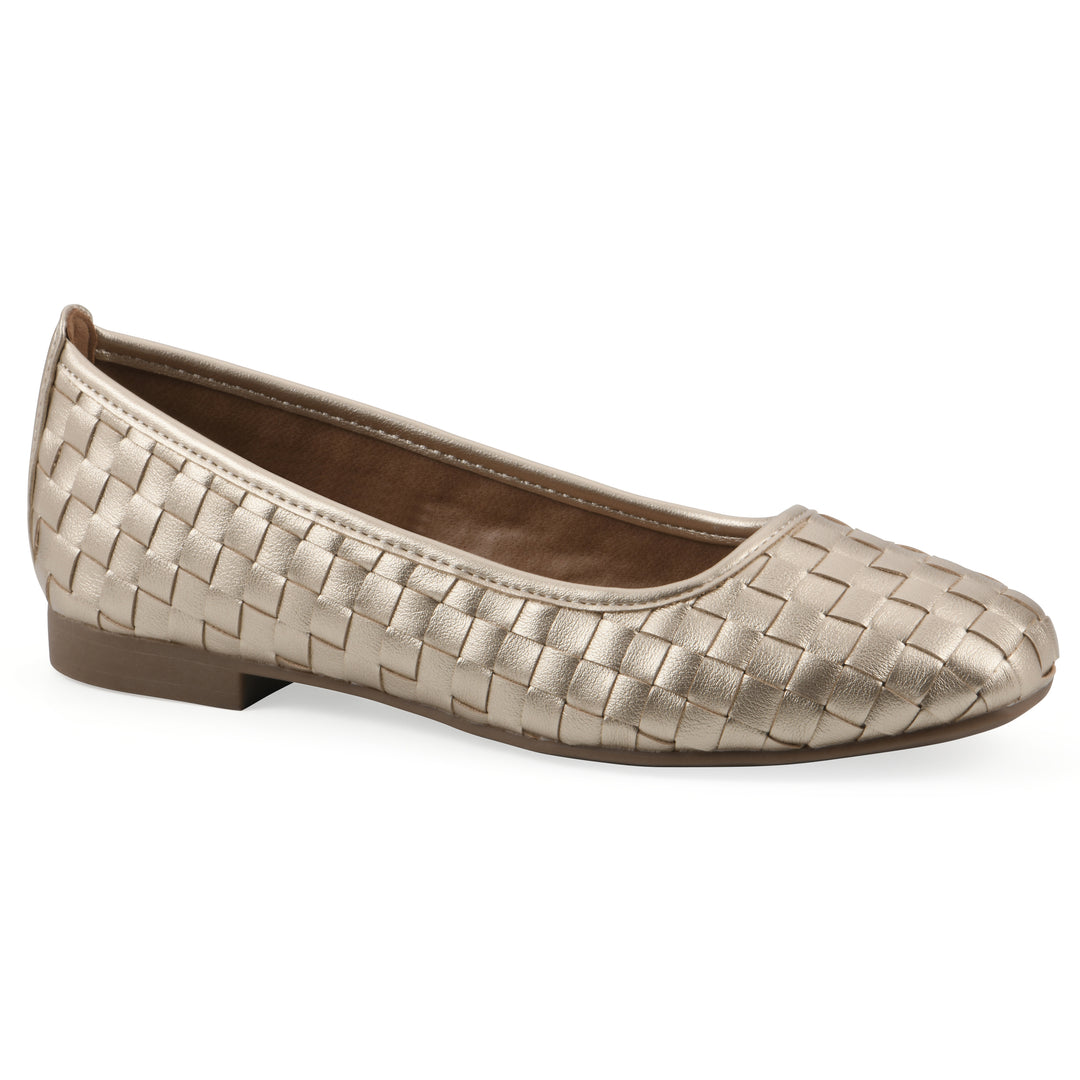 Angle view of a quilted style light gold flat with low brown sole