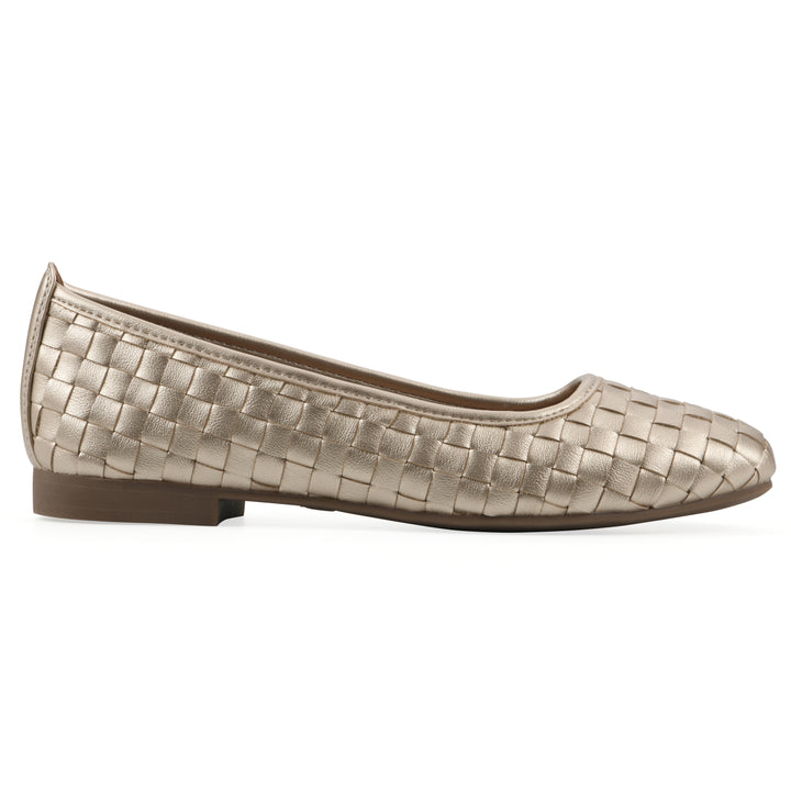 Side view of a quilted style light gold flat with low brown sole