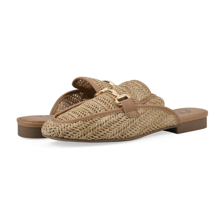 Angle view of a pair of natural raffia mules with horizontal metal embellishment and a black 1/2-inch heel