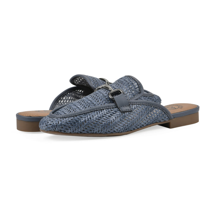 Angle view of a pair of blue raffia mules with horizontal metal embellishment and a black 1/2-inch heel