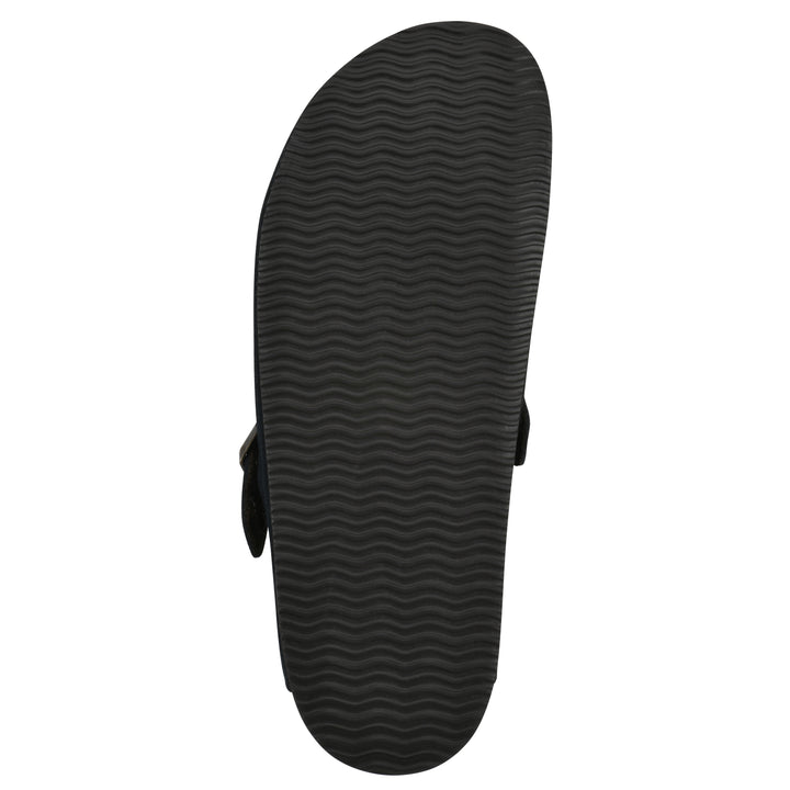 Sole view of a black suede backless clog with an adjustable buckle strap with stud and eyelet detailing and a black sole