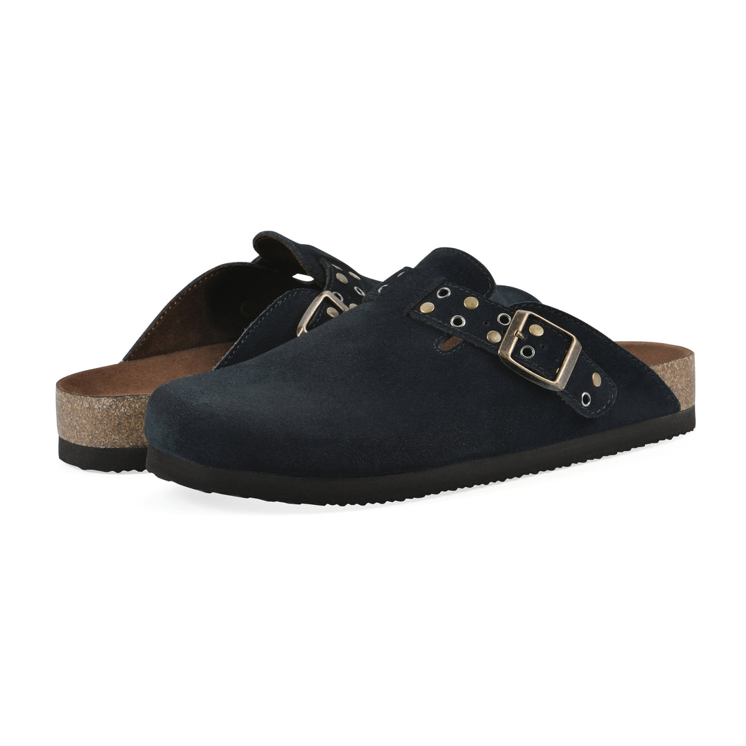 Angle view of a pair of black suede backless clogs with an adjustable buckle strap with stud and eyelet detailing and a black sole