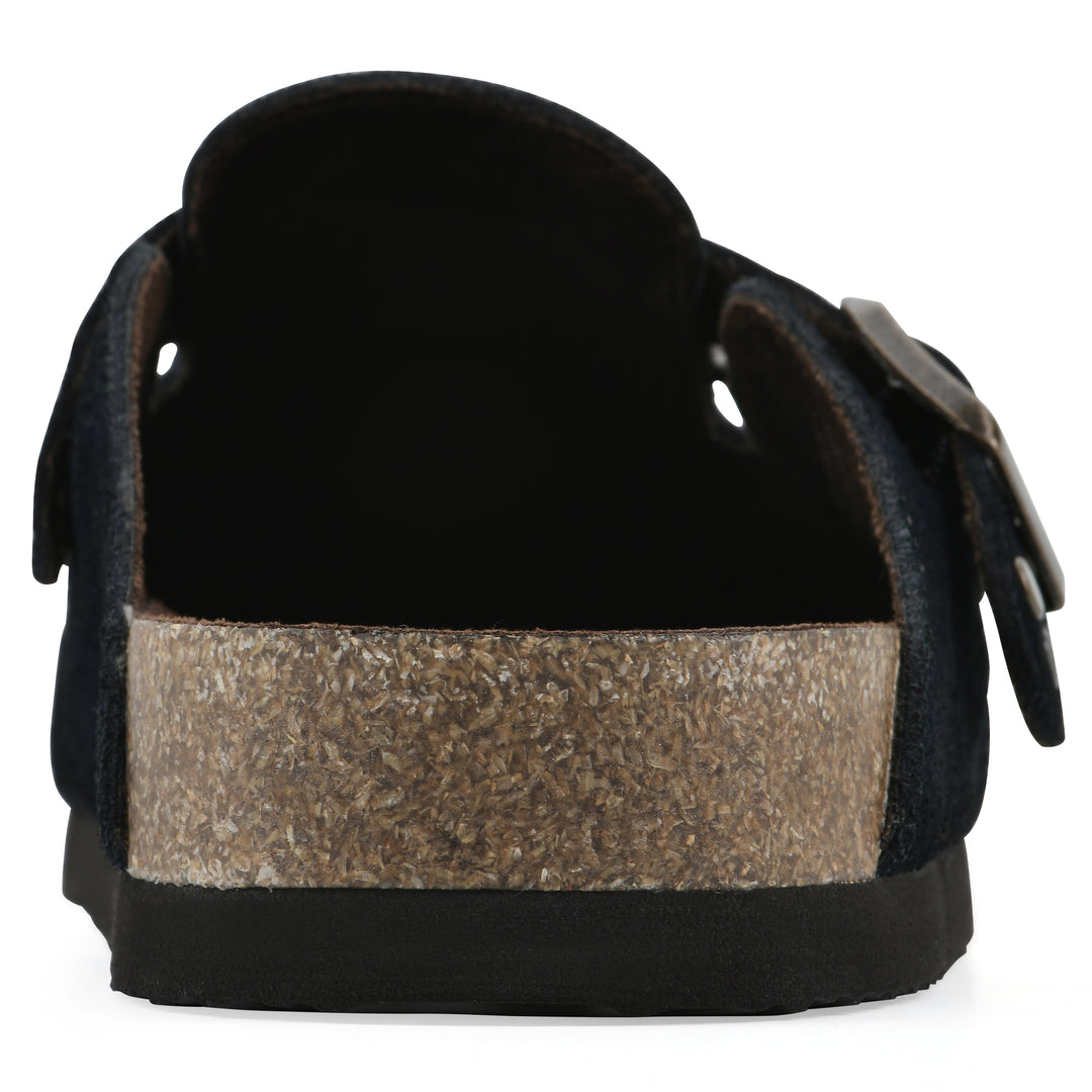 Rear view of a black suede backless clog with an adjustable buckle strap with stud and eyelet detailing and a black sole