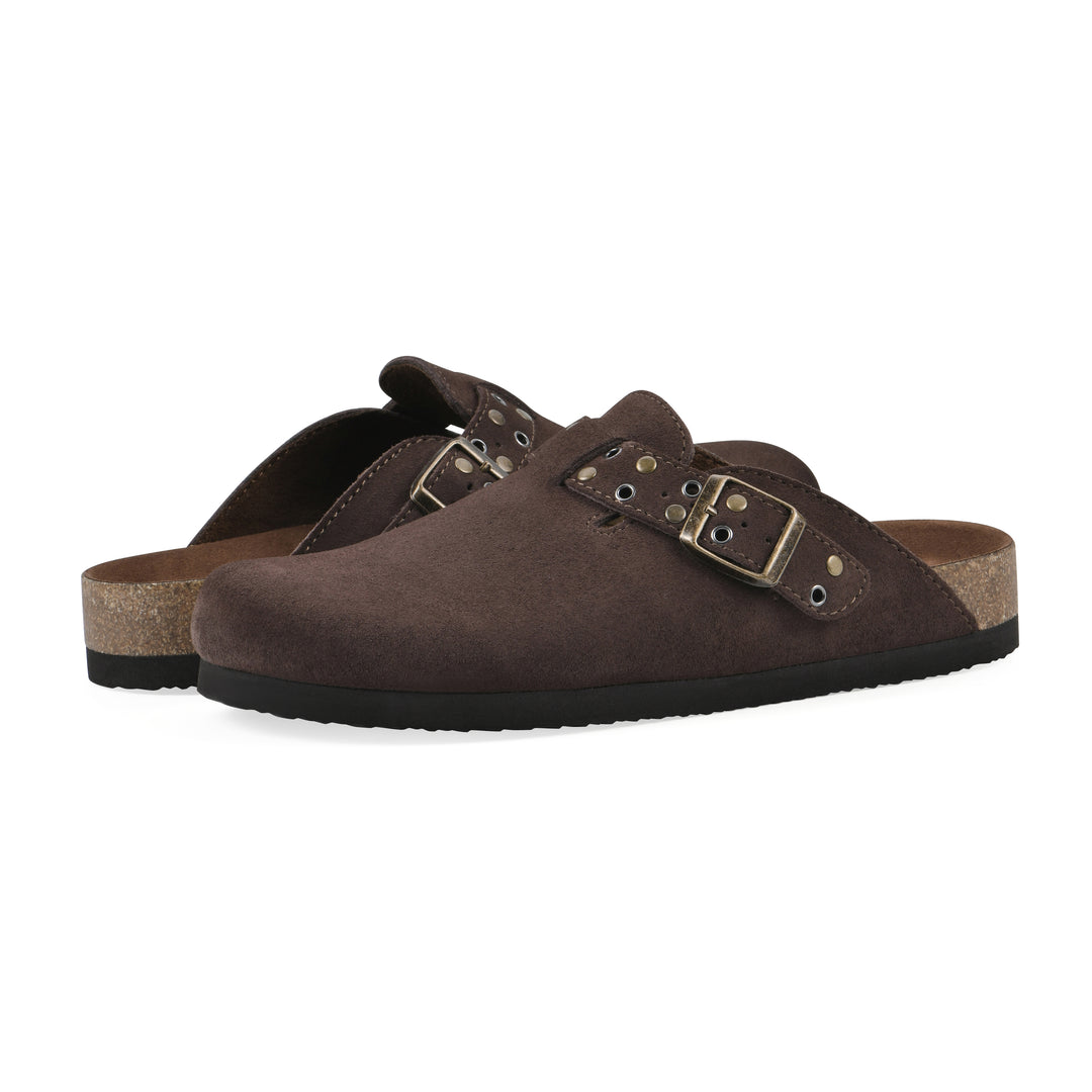 Angle view of a pair of brown suede backless clogs with an adjustable buckle strap with stud and eyelet detailing and a black sole
