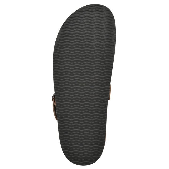 Sole view of a brown leopard suede backless clog with an adjustable buckle strap with stud and eyelet detailing and a black sole