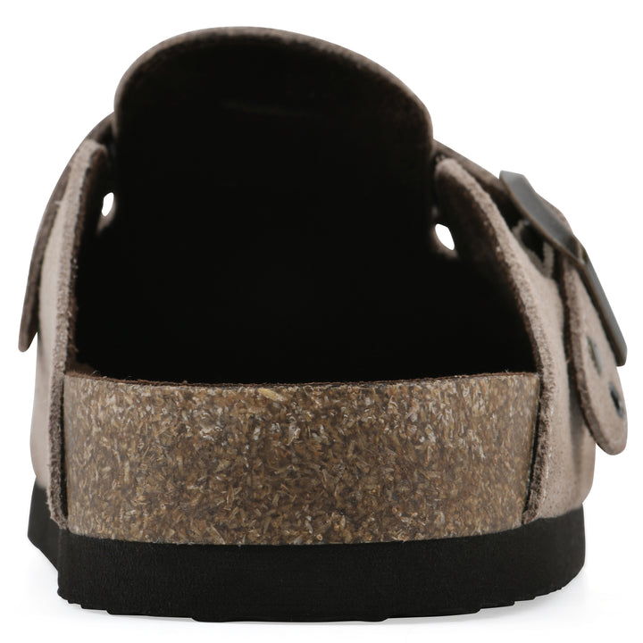 Rear view of a taupe suede backless clog with an adjustable buckle strap with stud and eyelet detailing and a black sole