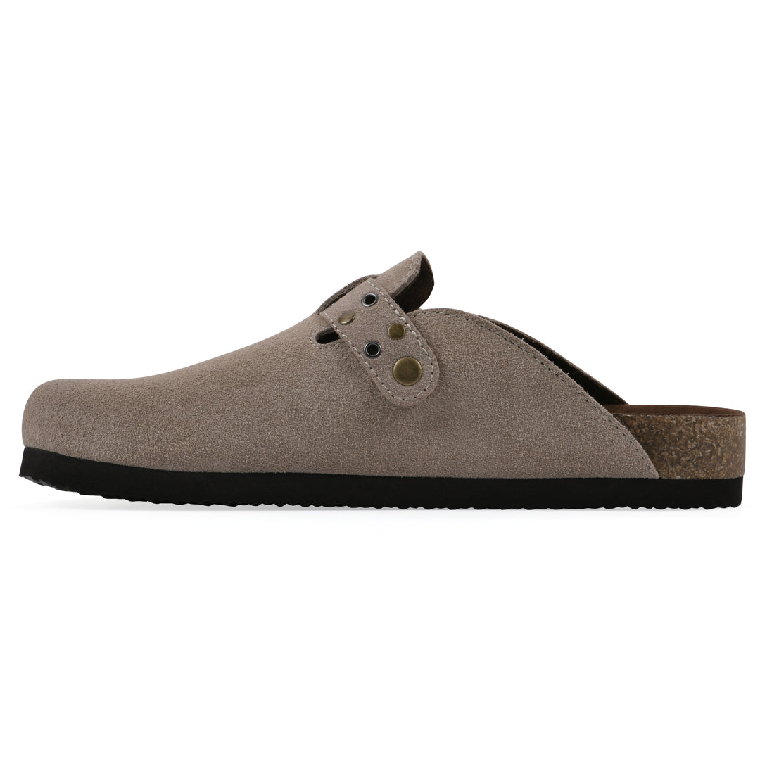 Side view of a taupe suede backless clog with an adjustable buckle strap with stud and eyelet detailing and a black sole