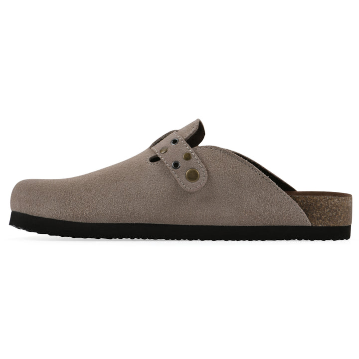 Side view of a taupe suede backless clog with an adjustable buckle strap with stud and eyelet detailing and a black sole