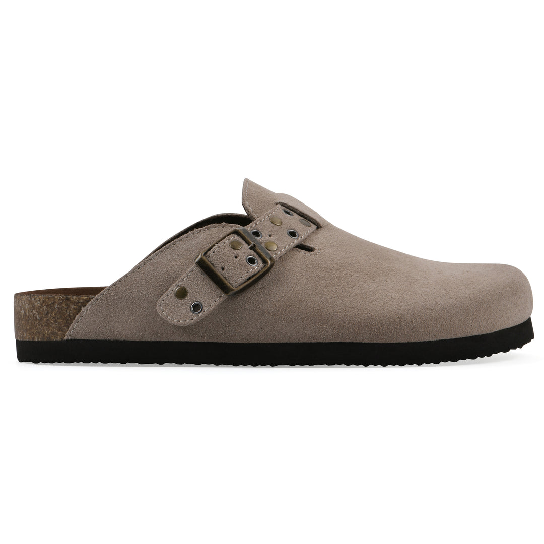 Side view of a taupe suede backless clog with an adjustable buckle strap with stud and eyelet detailing and a black sole