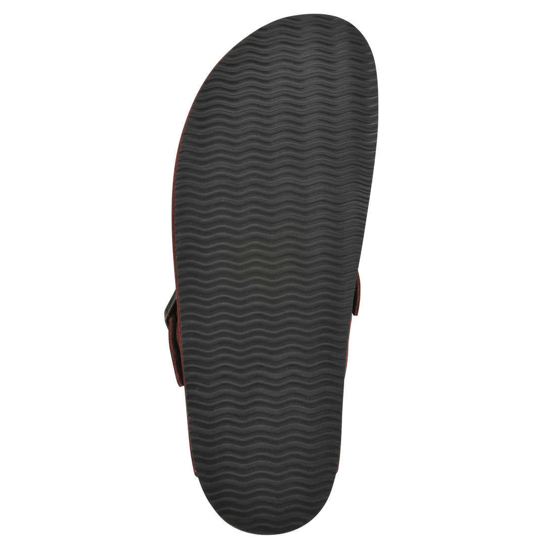 Sole view of a rust suede backless clog with an adjustable buckle strap with stud and eyelet detailing and a black sole