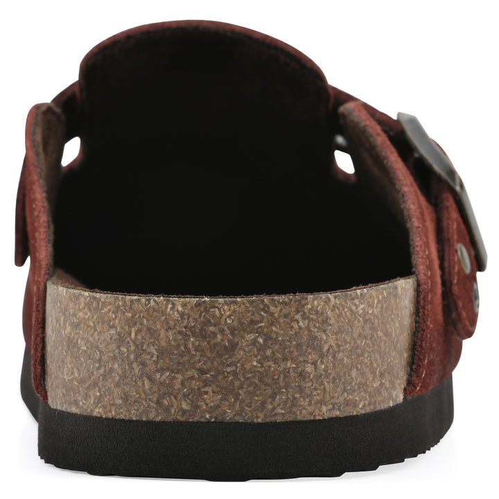 Rear view of a rust suede backless clog with an adjustable buckle strap with stud and eyelet detailing and a black sole